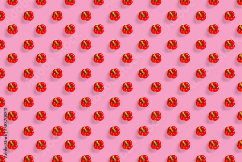 Bulgarian red ripe pepper on pink backdrop. background from paprika, flat lay not seamless pattern