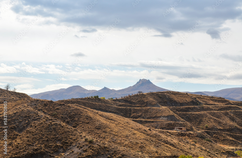 View of hilly relief, mountain slopes with sparse vegetation of autumn Caucasus mountains in Armenia View of hilly relief, mountain slopes with sparse vegetation of autumn Caucasus mountains in Armenia