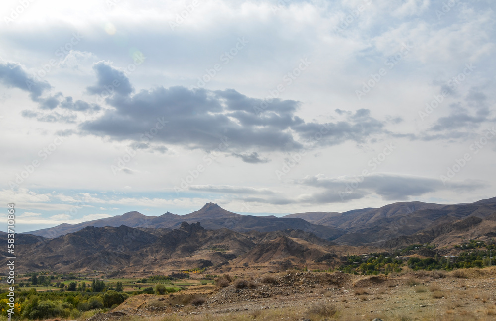 View of hilly relief, mountain slopes with sparse vegetation of autumn Caucasus mountains in Armenia
