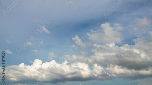 Light white clouds fly across a bright blue sky, Clear sky at sunny summer afternoon, Copy space.
 photo