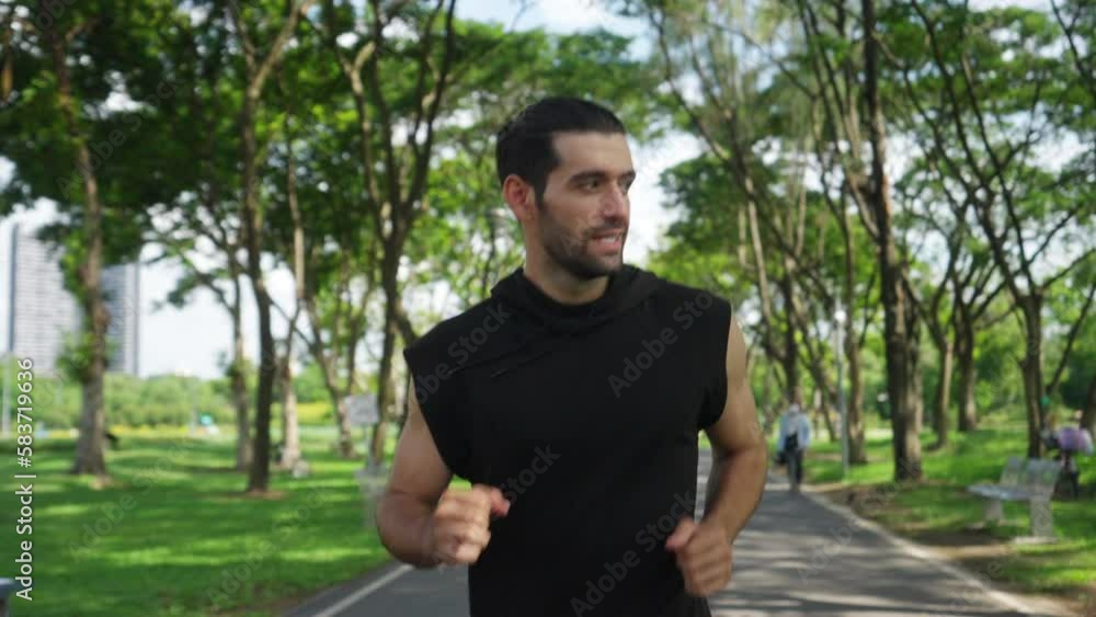 Handsome Caucasian man jogger in sportswear jogging exercise at public park in summer morning. Healthy guy athlete enjoy outdoor activity lifestyle sport training fitness running workout in the city. Handsome Caucasian man jogger in sportswear jogging exercise at public park in summer morning. Healthy guy athlete enjoy outdoor activity lifestyle sport training fitness running workout in the city.