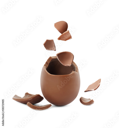 Exploded milk chocolate egg on white background