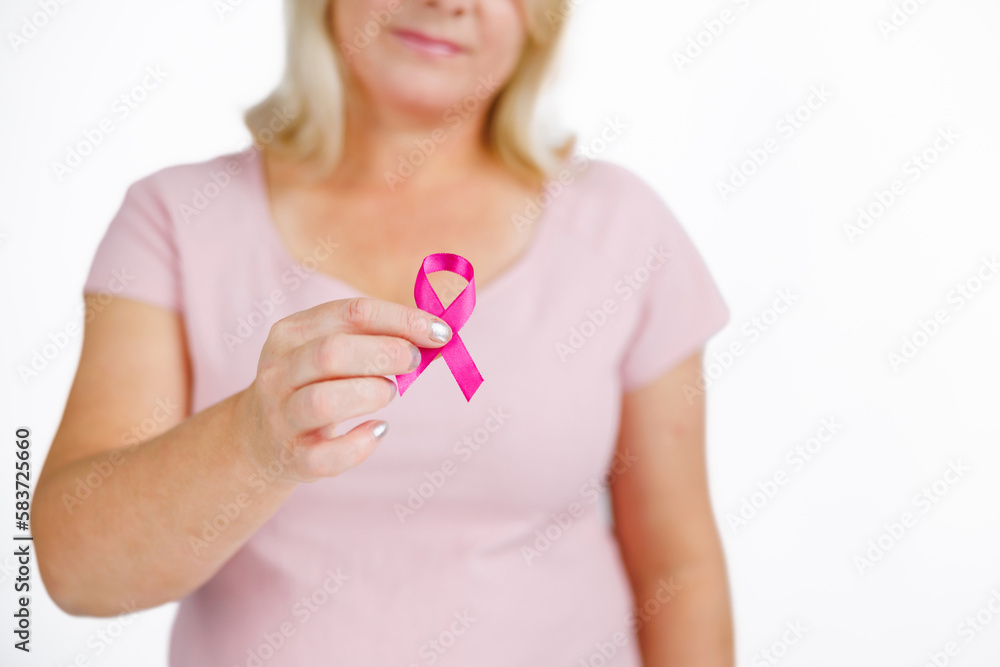 Woman in pink shirt with breast cancer awareness ribbon. Woman in pink shirt with breast cancer awareness ribbon.