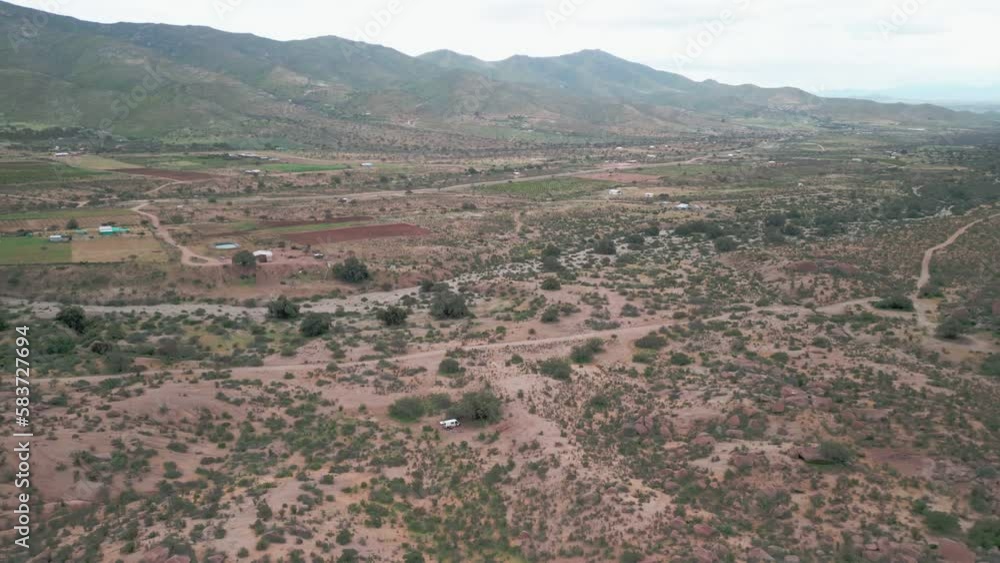 Drone landing on the Chilean country side with a camper in the distance. Drone landing on the Chilean country side with a camper in the distance.