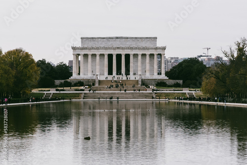 Washington D. C.  United States. November 29, 2022: abraham lincoln monument on a gray day and reflection in the water. photo