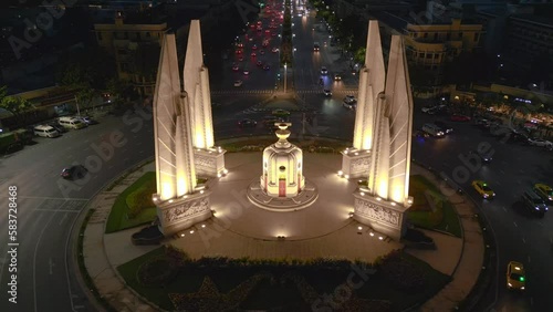 Traffic circle, big road with traffic. Majestic aerial view flight 
bangkok Democracy Monument at night thailand 2022. panorama overview drone
4k uhd cinematic footage. photo