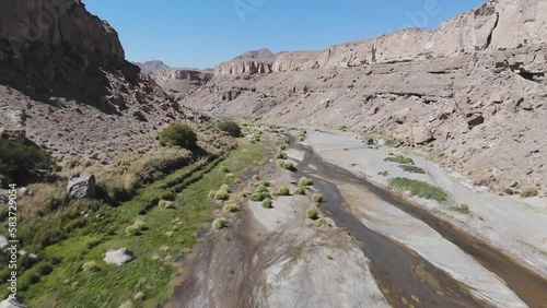 Badakhshan region of Afghanistan. Pyanj river and Pamir mountains. Pyanj is the headwaters of the Amu Darya River. Aerial view of a mountain landscape, sheep, and goats at the mouth of the river.