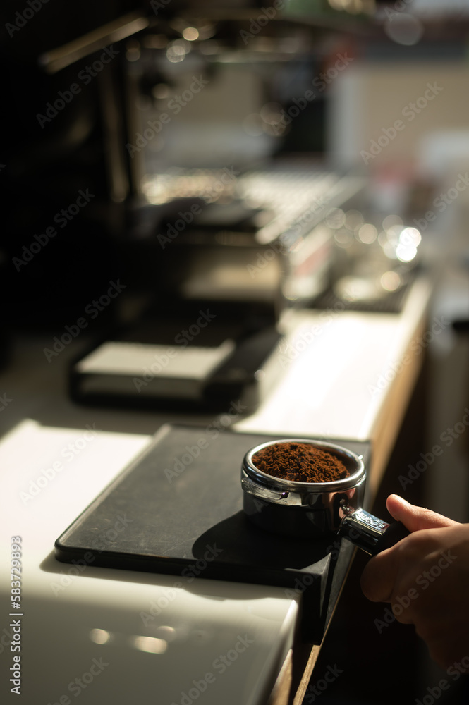 Hand of Barista Holding a Coffee Tamper