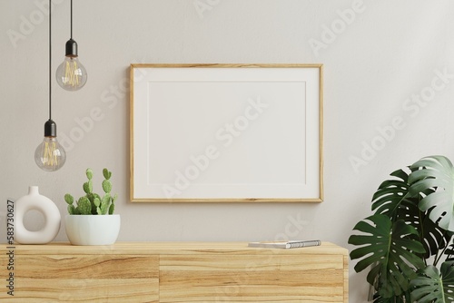 Horizontal picture frame mockup on empty wooden cabinet. photo