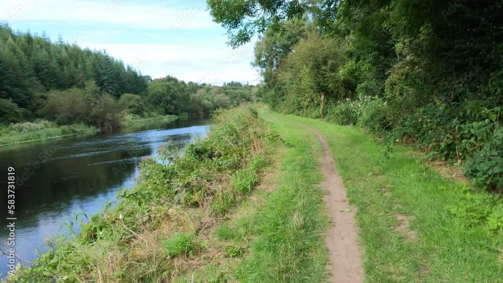 Cycling along the river Barrow towpath Griguenamanagh Kilkenny on a warm summer morning