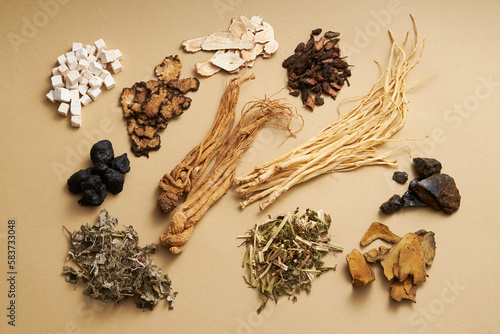 Top view of ancient Chinese herbs on light brown background. Advertising scene for health care products, derived from natural herbs photo