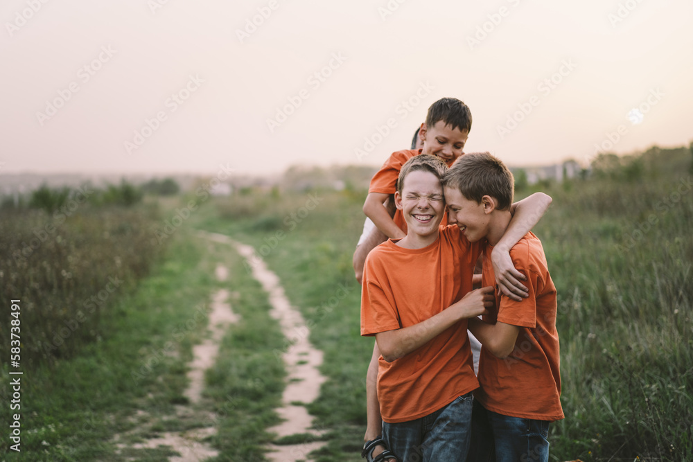 Happy Fathers day. Father with son are walking in the field. Dad hugs boy. The concept of Fathers day, relationships with children, care and love. Happy Fathers day. Father with son are walking in the field. Dad hugs boy. The concept of Fathers day, relationships with children, care and love.