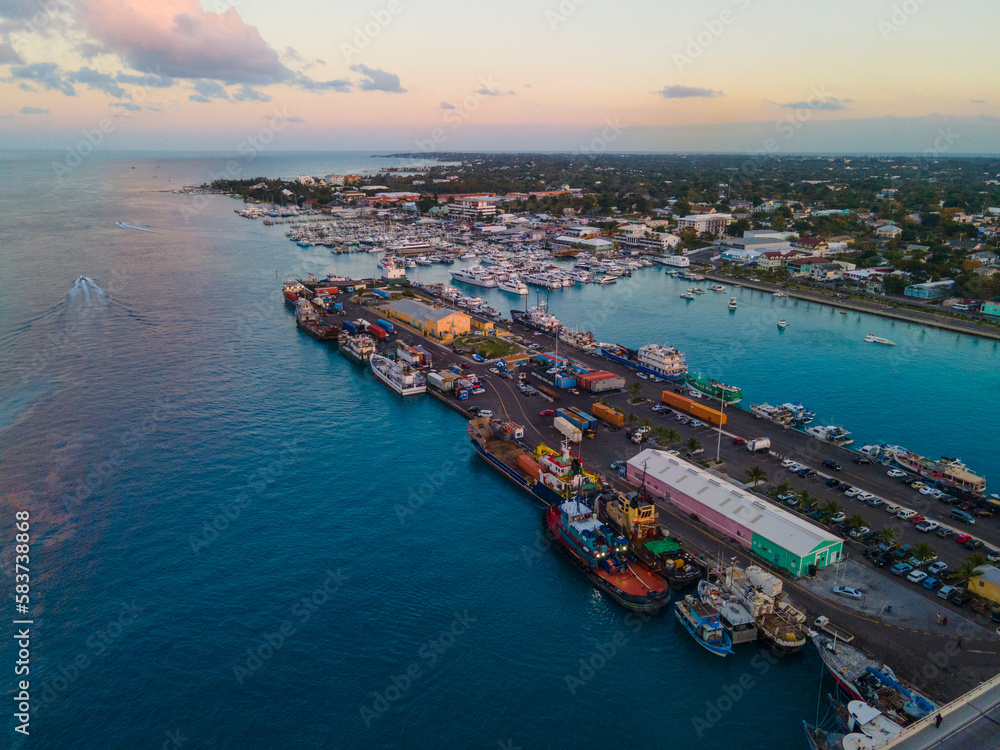 Nassau Potters Cay and downtown aerial view at sunset in Nassau Harbour, New Providence Island, Bahamas. 