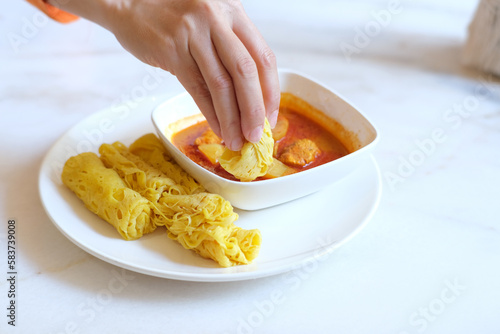 Roti Jala is a popular Malay and Minangkabau tea time snack served with curry dishes which can be found in Indonesia, Malaysia and Singapore.  photo