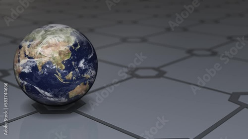 左の地面のタイルに置かれた回転する地球 photo