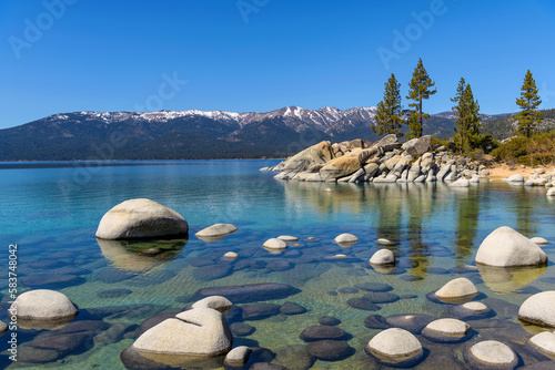 Murais de parede Rocky Blue Lake - A calm Spring day view of a crystal-clear rocky cove at Sand Harbor of Lake Tahoe, California-Nevada, USA