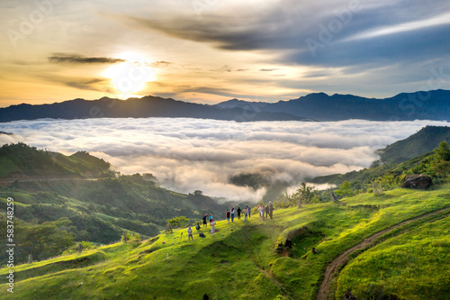 Panoramic view of sunrise with a trail going through a valley filled with white clouds in the Tak Po mountains in Tra Tap commune, Nam Tra My district, Quang Nam province, Vietnam photo