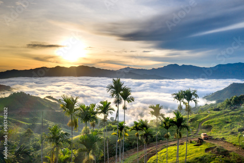Panoramic view of sunrise with a trail going through a valley filled with white clouds in the Tak Po mountains in Tra Tap commune  Nam Tra My district  Quang Nam province  Vietnam