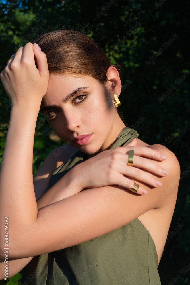 Obraz premium Girl beauty face on palm leaves. Summer portrait of beautiful young woman. Beauty summer female portrait. Sexy woman enjoying summer vacation.