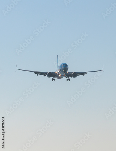 View of modern passenger plane aircraft in flight  commercial airplane flying in the sky before take off or landing  with mountains in the background in a summer sunny day