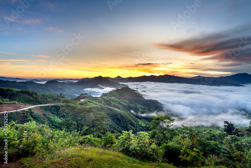 Panoramic view of sunrise with a trail going through a valley filled with white clouds in the Tak Po mountains in Tra Tap commune, Nam Tra My district, Quang Nam province, Vietnam © Quang