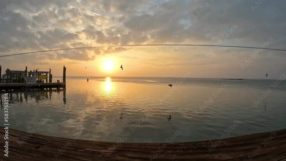 Time lapse of a peacefeul sunset over a pier on Laguna Madra near Corpus Christi, Texas; concepts of tourism, tranquility Time lapse of a peacefeul sunset over a pier on Laguna Madra near Corpus Christi, Texas; concepts of tourism, tranquility