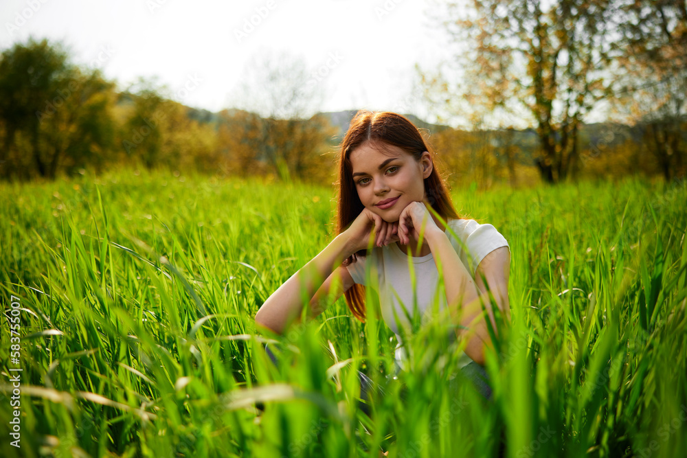 Beautiful healthy Young Woman relaxing on the green grass Beautiful healthy Young Woman relaxing on the green grass