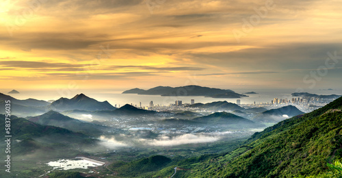 Panoramic photo of dawn viewed from the high mountains, in the distance is the famous coastal tourist city of Nha Trang, Khanh Hoa province, Vietnam