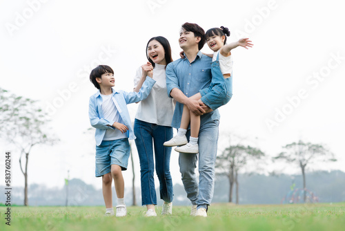 Asian family photo walking together in the park