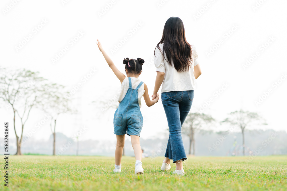 image of mother and daughter playing in the park image of mother and daughter playing in the park