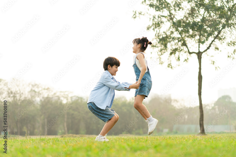 image of brother and sister having fun in the park