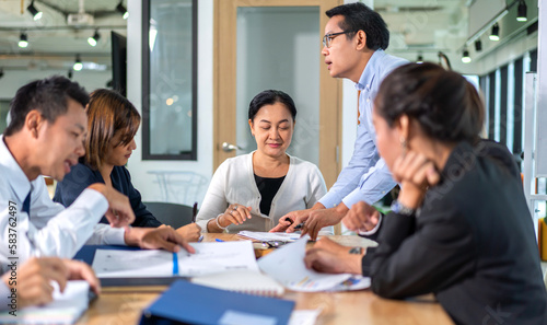 Group of creative asian business meeting and discussing strategy startup project analysis finance process.Success asian business people work plan and brainstorm marketing idea in office.Teamwork