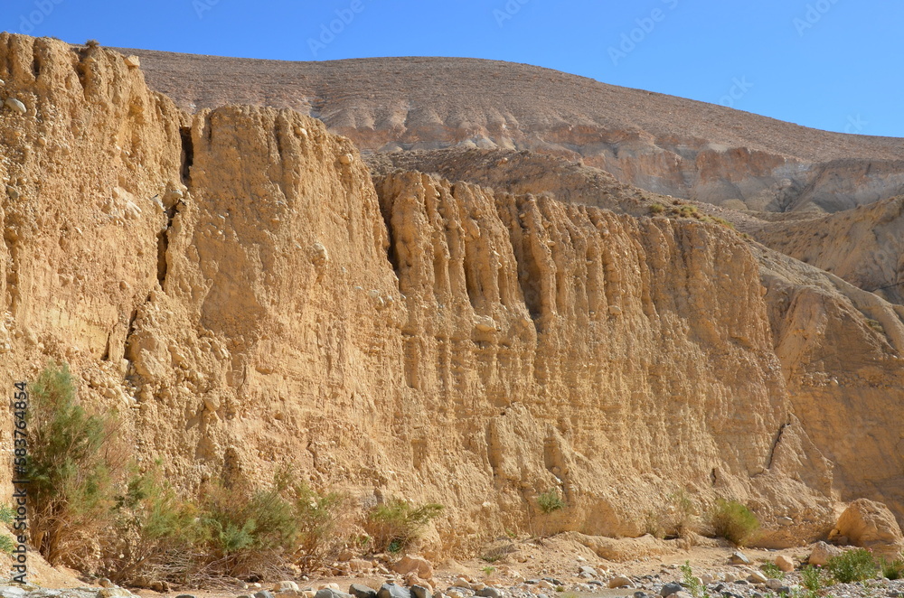 Fototapeta premium Beautiful rocks and canyons in the wild nature and the dry desert of Wadi Ghweir in Jordan on a bright sunny day