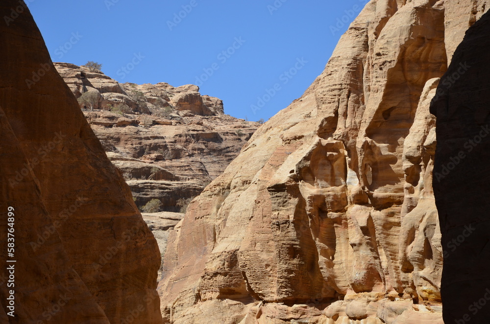 Fototapeta premium Beautiful rocks and canyons in the wild nature and the dry desert of Wadi Ghweir in Jordan on a bright sunny day