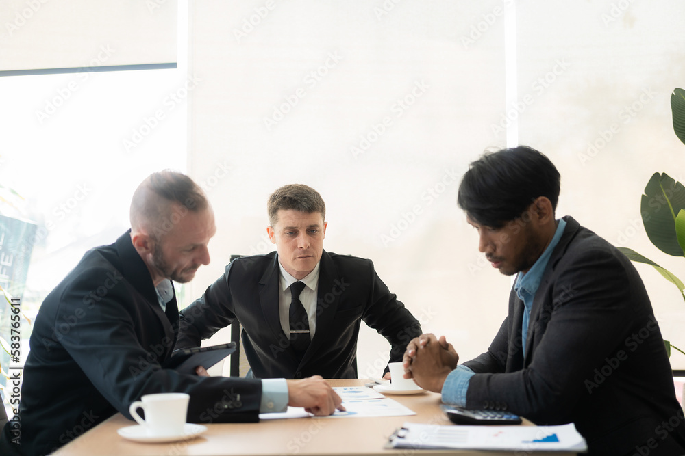Diverse teams of top managers discuss, brainstorm, use digital tablets. Business partners discuss financial reports. Planning investment strategy in real estate Diverse teams of top managers discuss, brainstorm, use digital tablets. Business partners discuss financial reports. Planning investment strategy in real estate