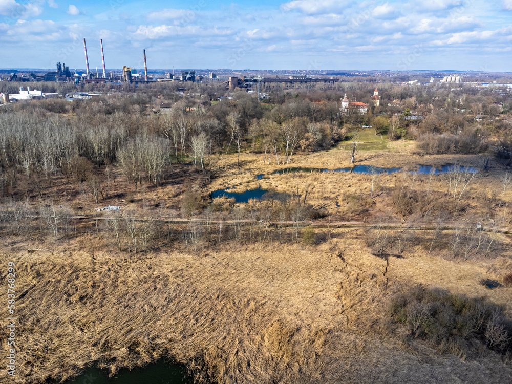 Aerial view landscape. Factory chimneys, ponds, dry grass, industry.