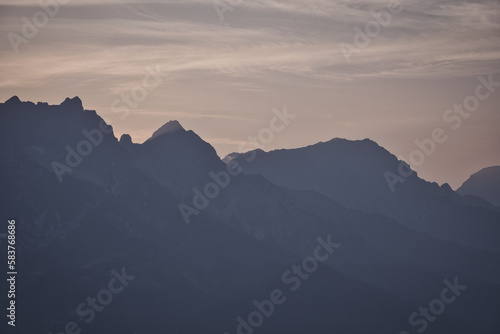 Mountains silhouette with peaks in the morning mist Saalfelden  Salzburg  Austria