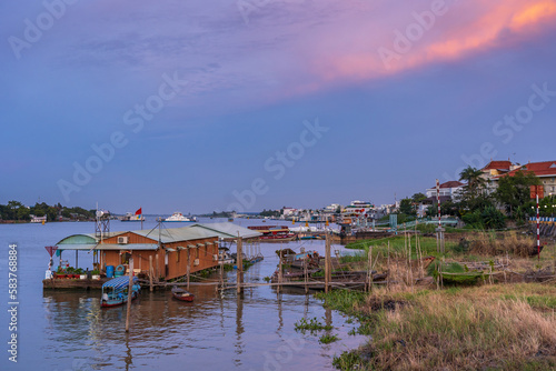 A coloured sky over houses built over a river at Chau Doc in Vietnam