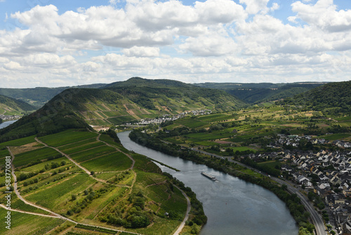 Bird's eye view of a village near the Moselle loop surrounded by greenery and vineyards in Germany