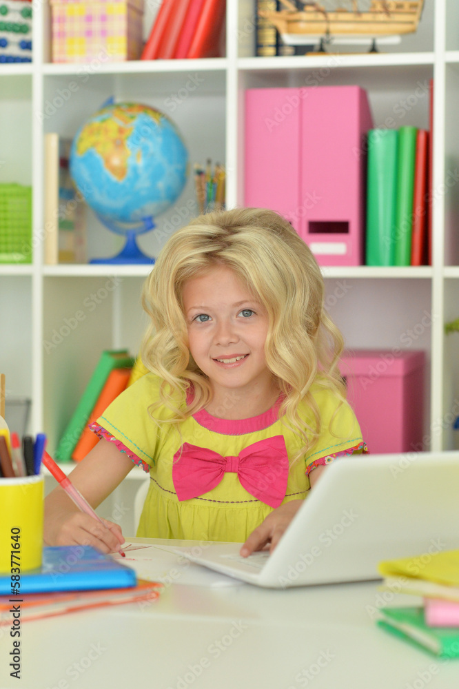 girl using laptop at desk at home girl using laptop at desk at home