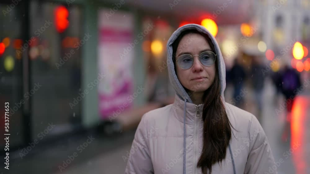 walk in city in winter day, snow falling on woman strolling in downtown, medium portrait walk in city in winter day, snow falling on woman strolling in downtown, medium portrait