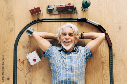 Senior Man Playing With Model Train