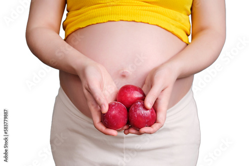 Plum fruit in the hands of a pregnant woman, isolated on a white background