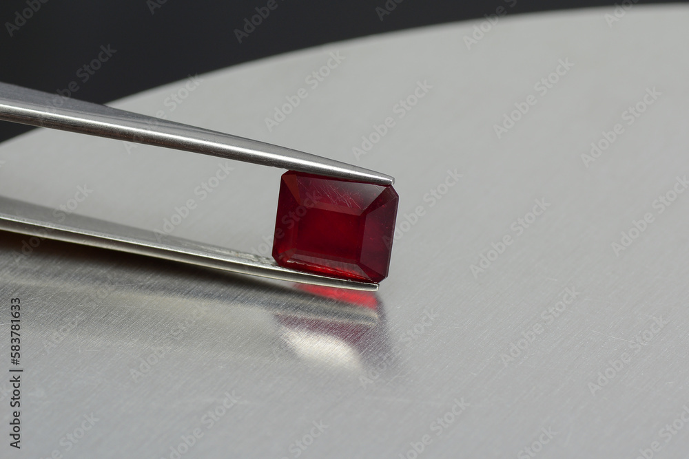 Natural mined heated lead glass filled treated emerald cut square faceted red ruby corundum loose semitransparent gemstone setting for jewelry making. Micro cracks on gemstone surface, bubbles insde. Natural mined heated lead glass filled treated emerald cut square faceted red ruby corundum loose semitransparent gemstone setting for jewelry making. Micro cracks on gemstone surface, bubbles insde.
