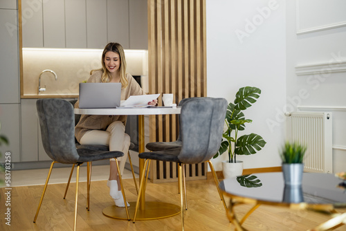 Portrait of young woman working at home office