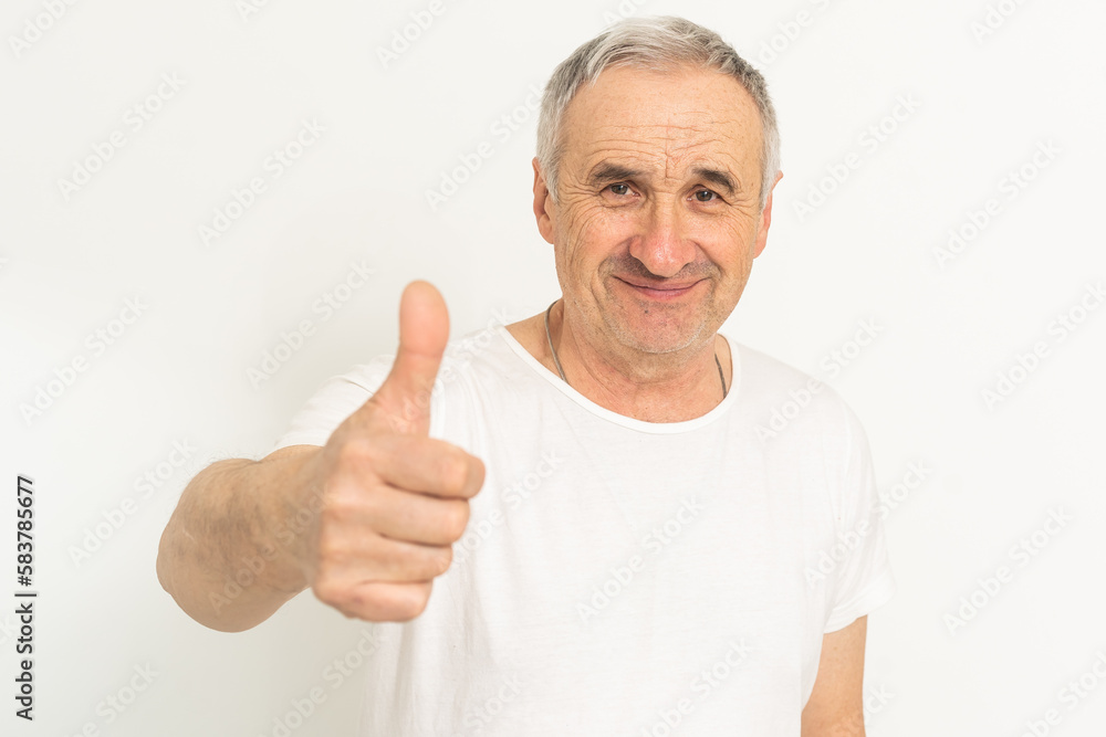 an elderly man shows a thumbs up an elderly man shows a thumbs up