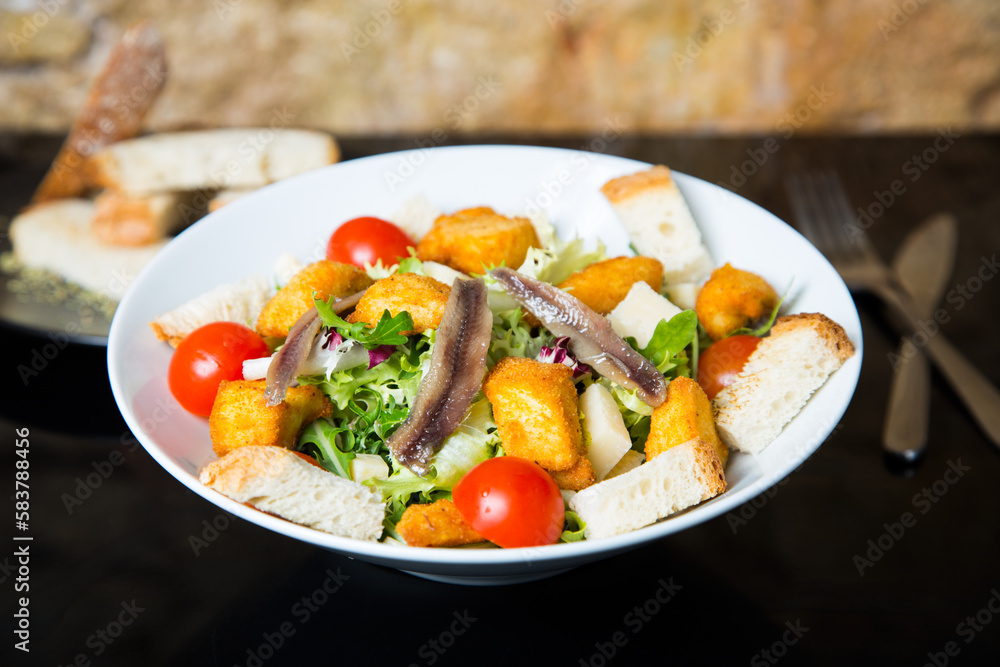 Delicious salad with anchovies and battered cheese. Delicious salad with anchovies and battered cheese.