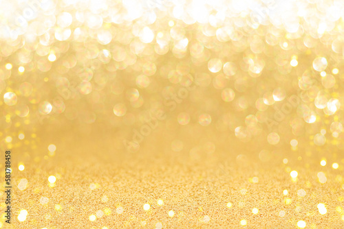 Golden sparkling background with shiny blurred round bokeh.