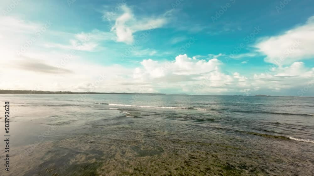 Fpv drone shot over shallow turquoise water surface in Siargao - Philippines