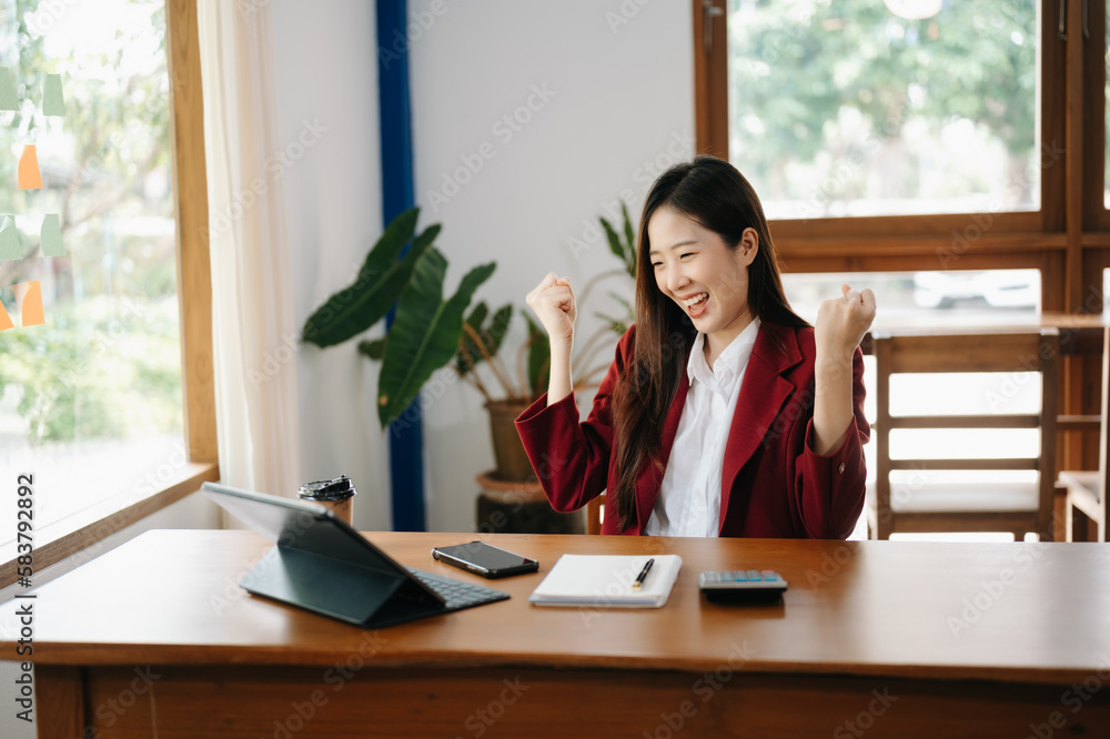Asian business woman are delighted and happy with the work they do on their tablet, laptop and taking notes at the office.. Asian business woman are delighted and happy with the work they do on their tablet, laptop and taking notes at the office..